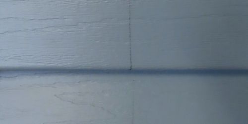 Close-up of blue vinyl siding. 