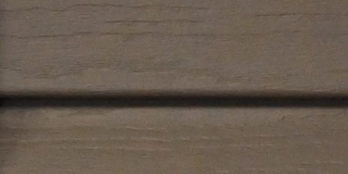 Close-up of khaki vinyl siding.