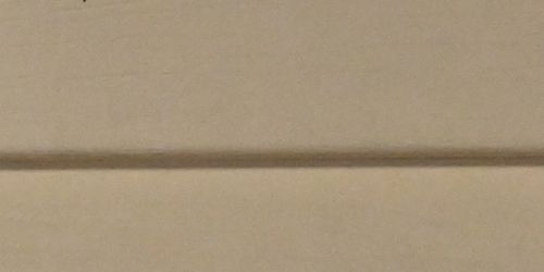 Close up of prairie white vinyl siding. 