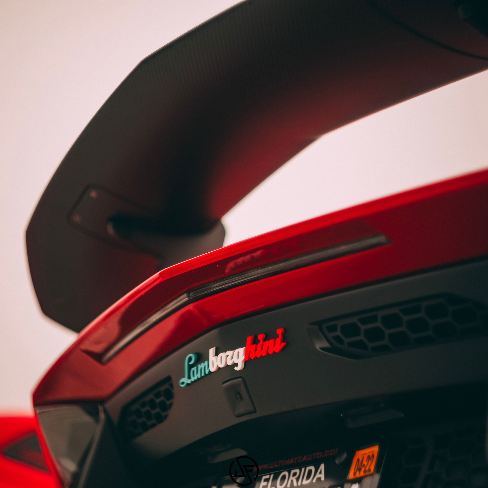 Close-up of red Lamborghini rear, black spoiler, 