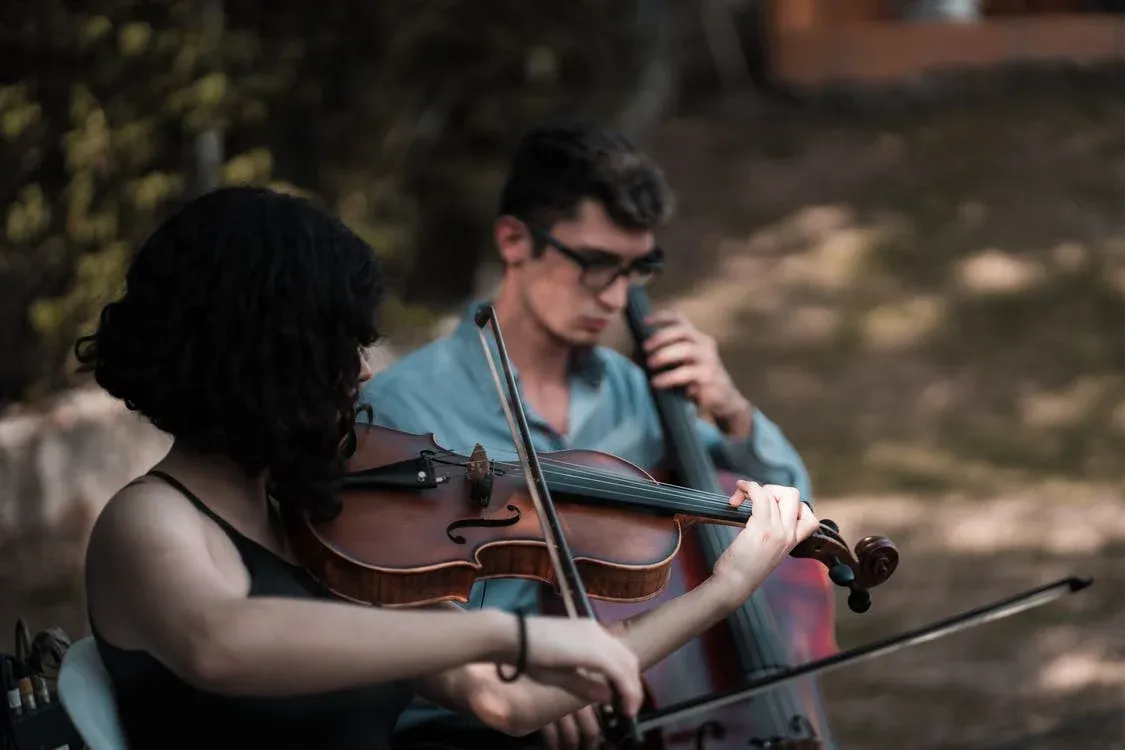 man and woman playing violin