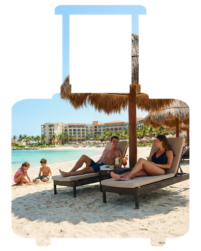 People relaxing on beach loungers under a thatched shade at a resort beach.