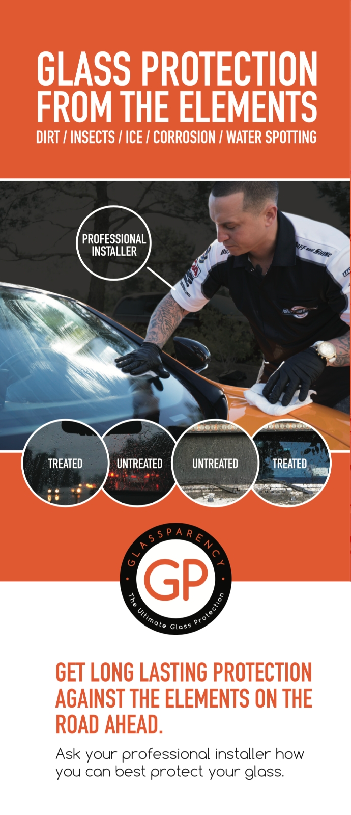 A man is cleaning the windshield of a car.