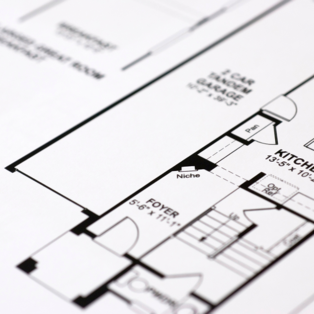 A black and white floor plan of a house shows the kitchen and foyer