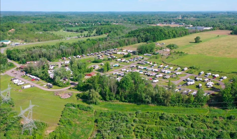 An aerial view of a campground surrounded by trees and grass.