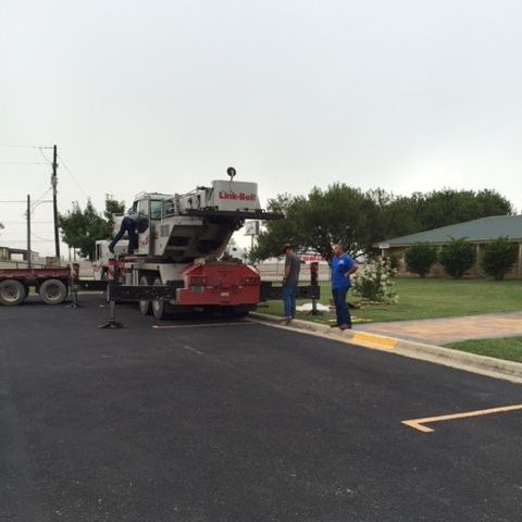 A group of men are standing next to a truck in a parking lot from AFA Service