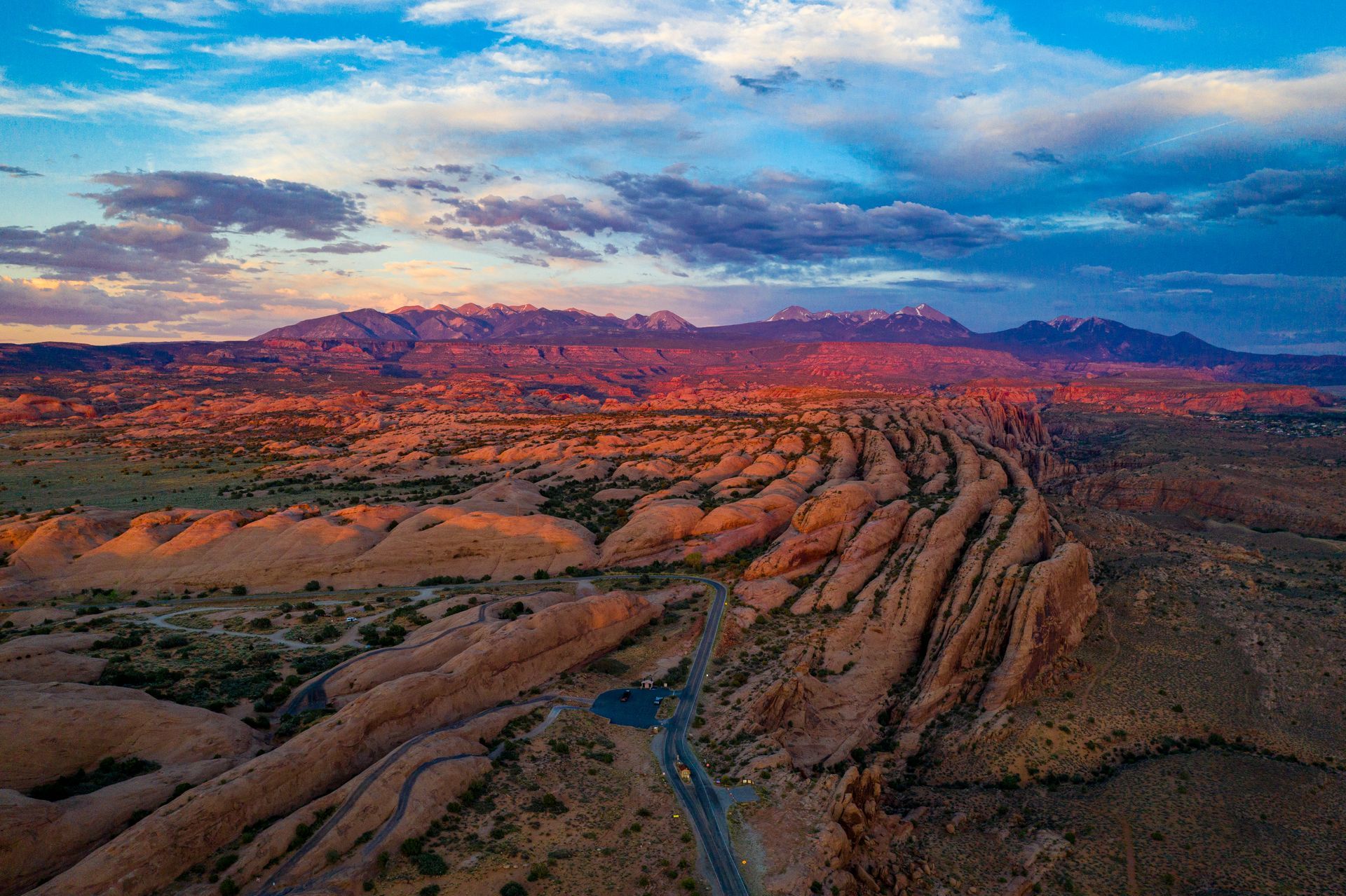 Sandstone fins curve into the distance in an area with an off road trail knows as Fins N Things.
