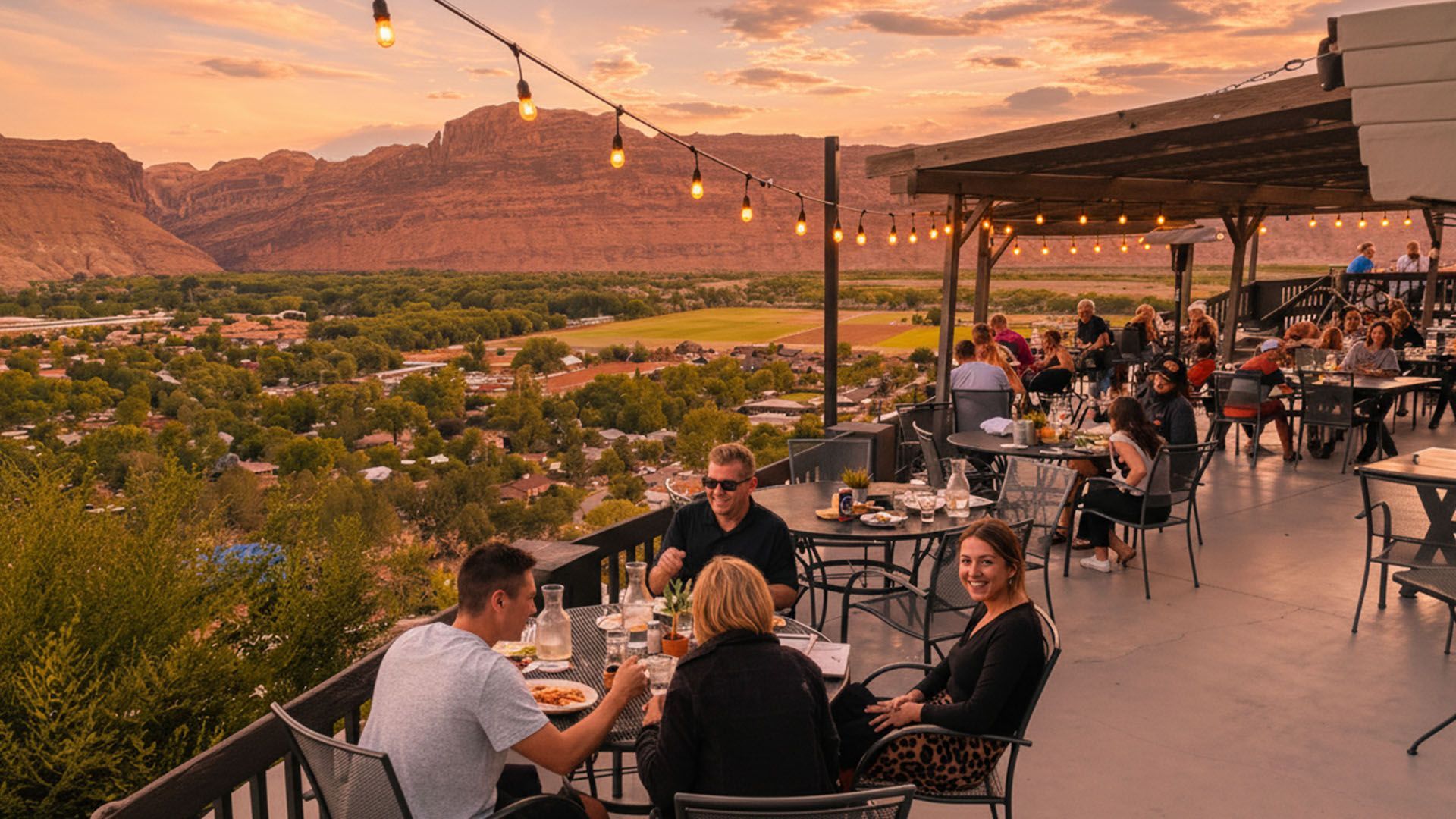 Patrons at the Sunset Grill enjoying dinner on the patio overlooking The Portal area of Moab.
