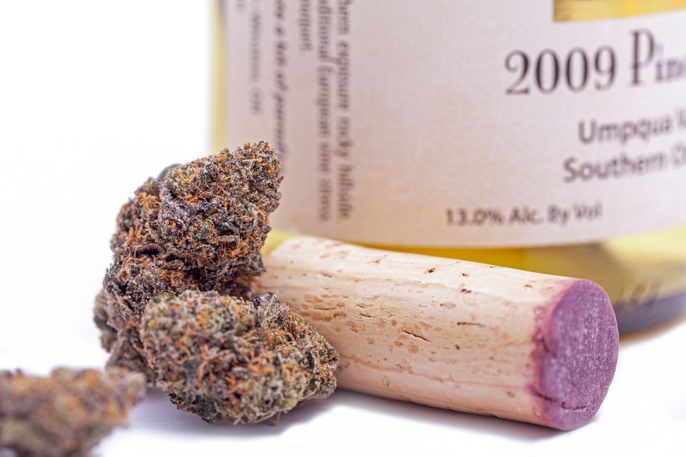 Cannabis buds, wine cork, and wine bottle with 