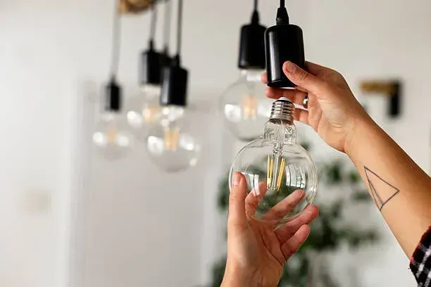 Installing a globe LED light bulb.