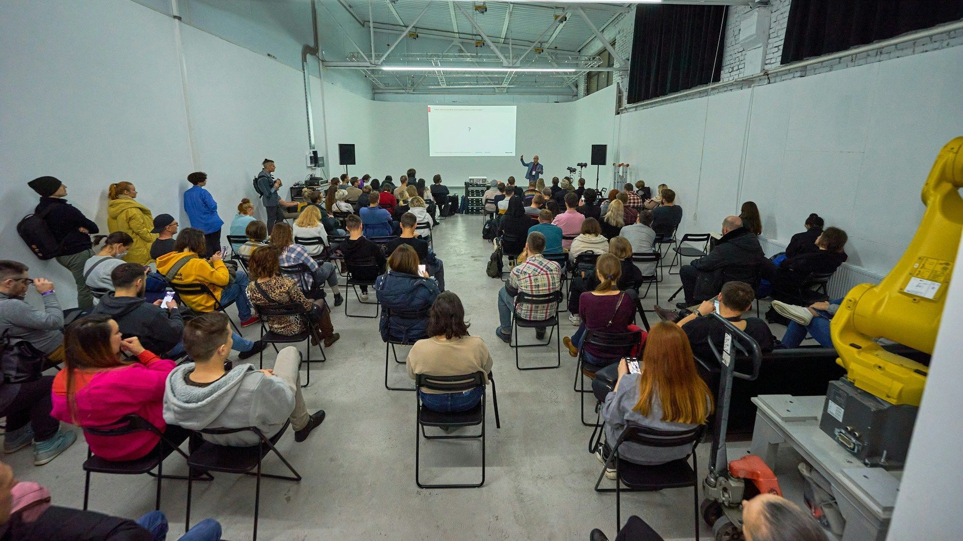 Group of people in large hall attending PD or training