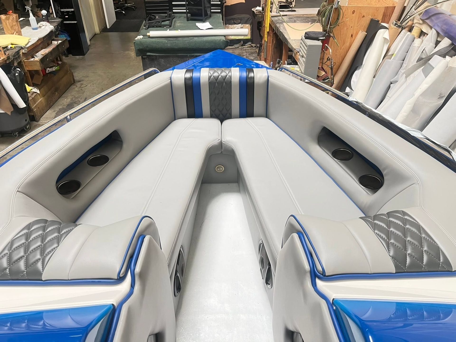 White and gray boat interior with blue accents, shown in a shop aisle