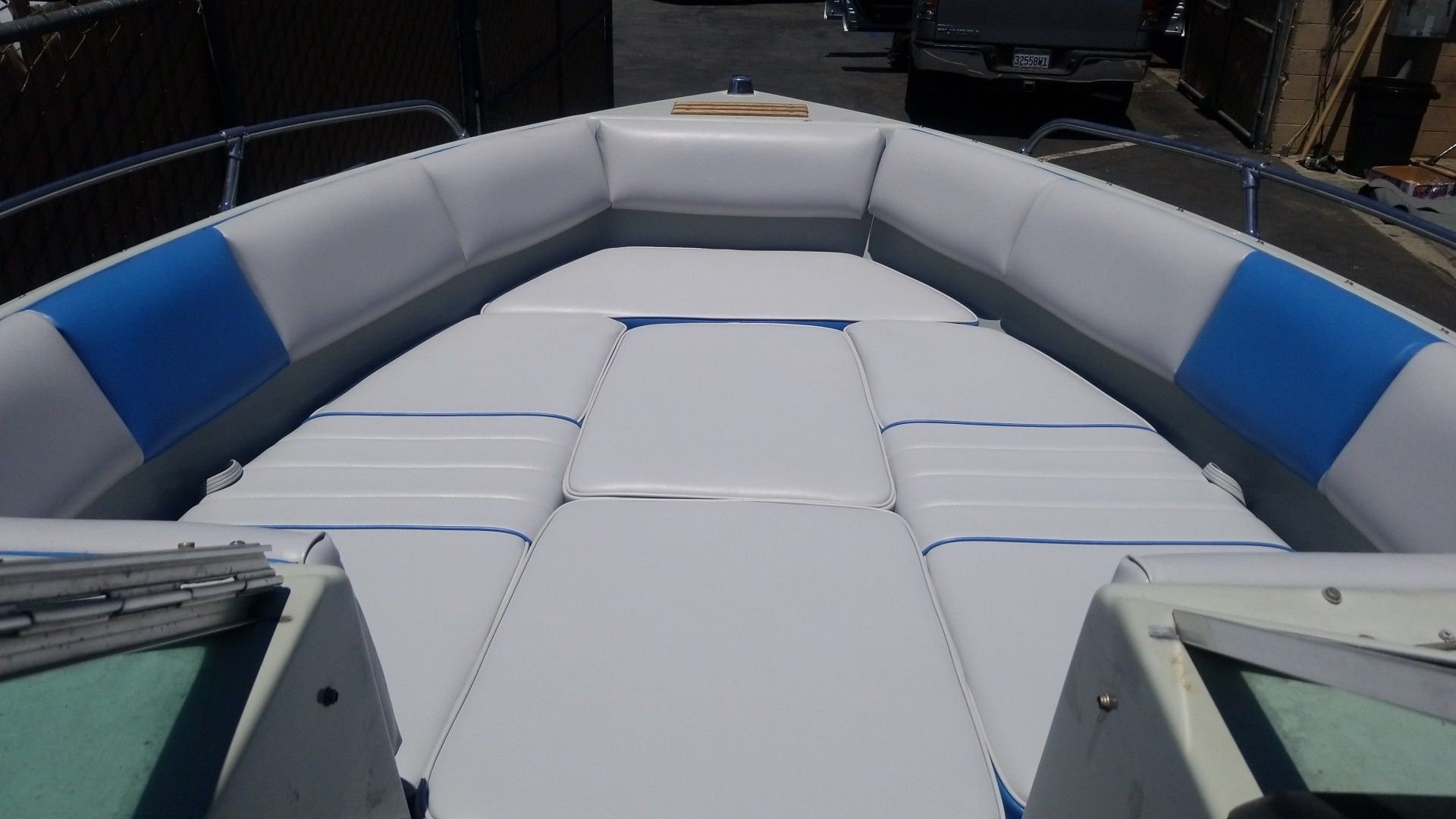 White cushioned boat bow with blue side panels, viewed from the front onboard the vessel