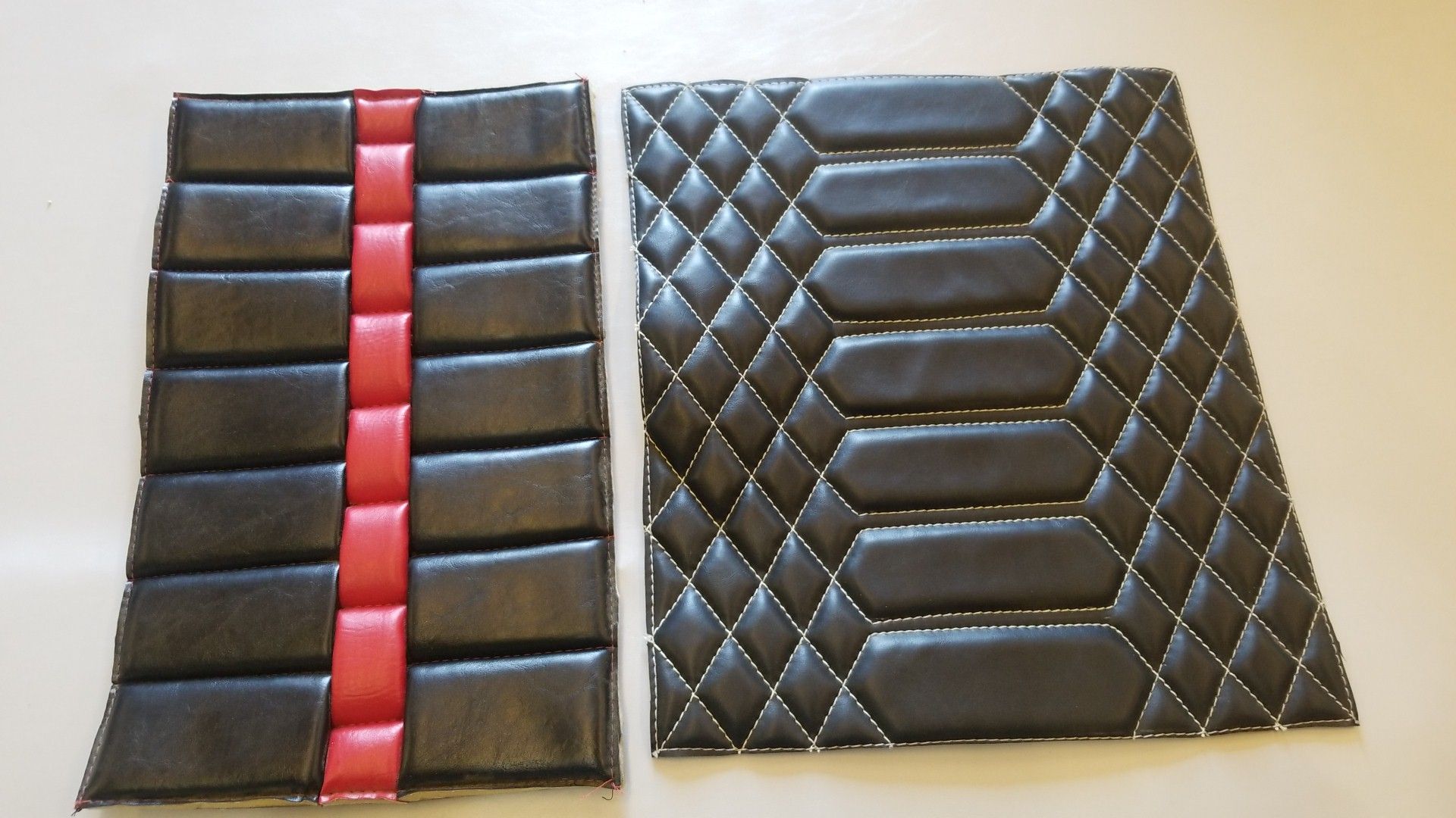 Two black quilted panels, one with a red vertical center strip, on a light background