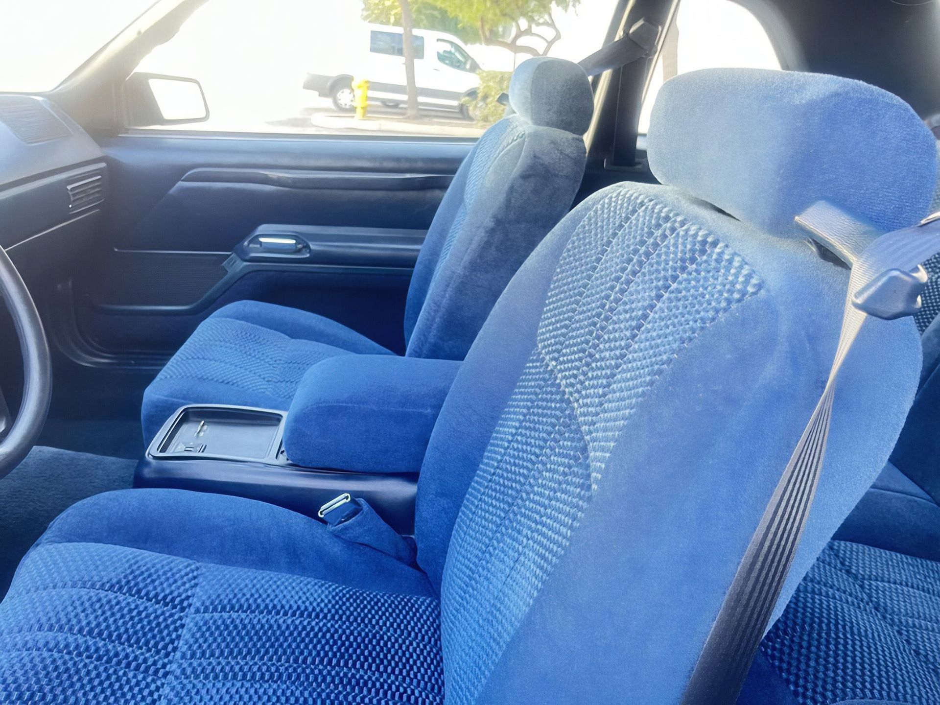 Blue car interior with plush blue seats and steering wheel visible