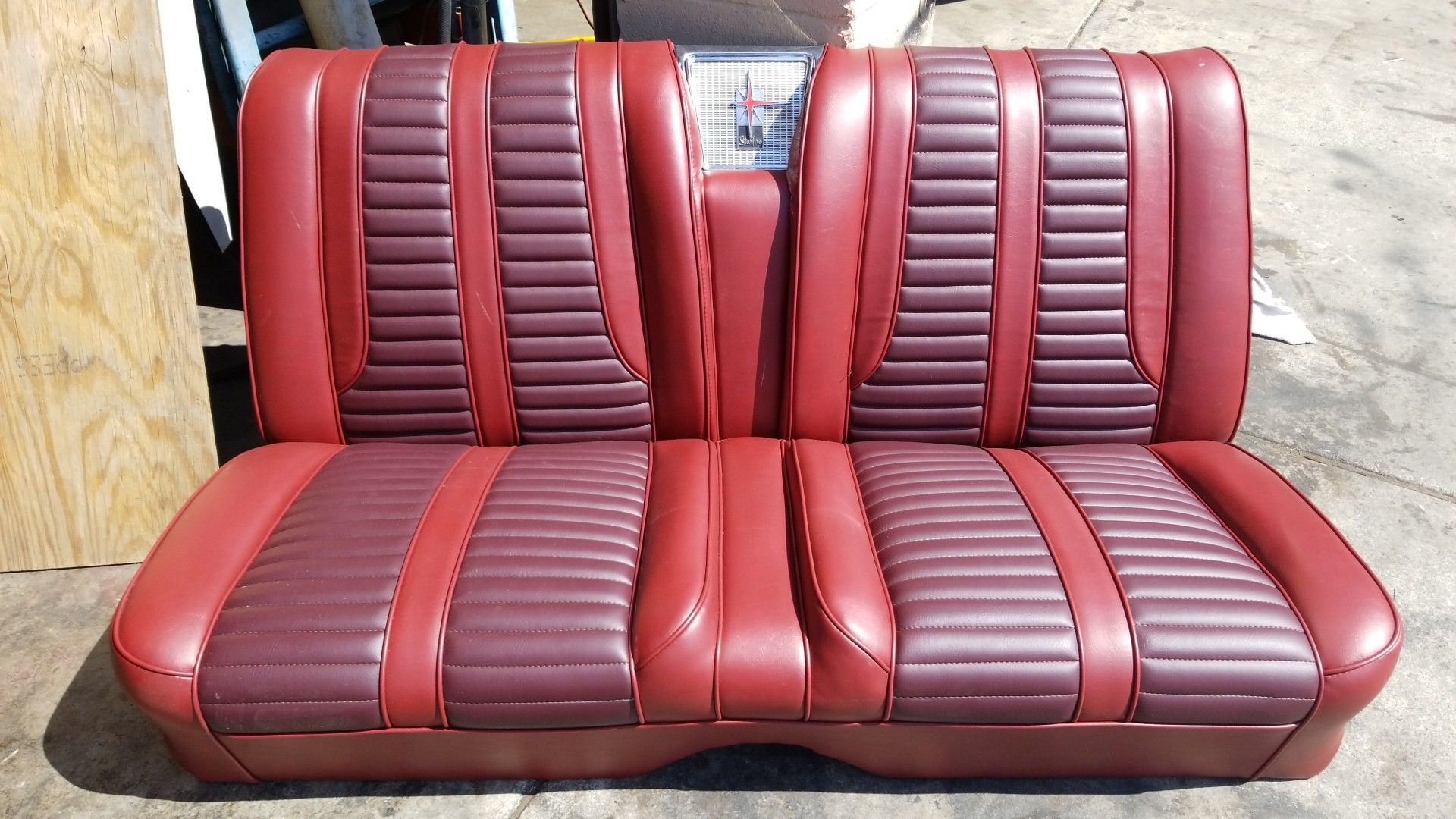 Red and burgundy striped car bench seat upholstery with fold-down center section