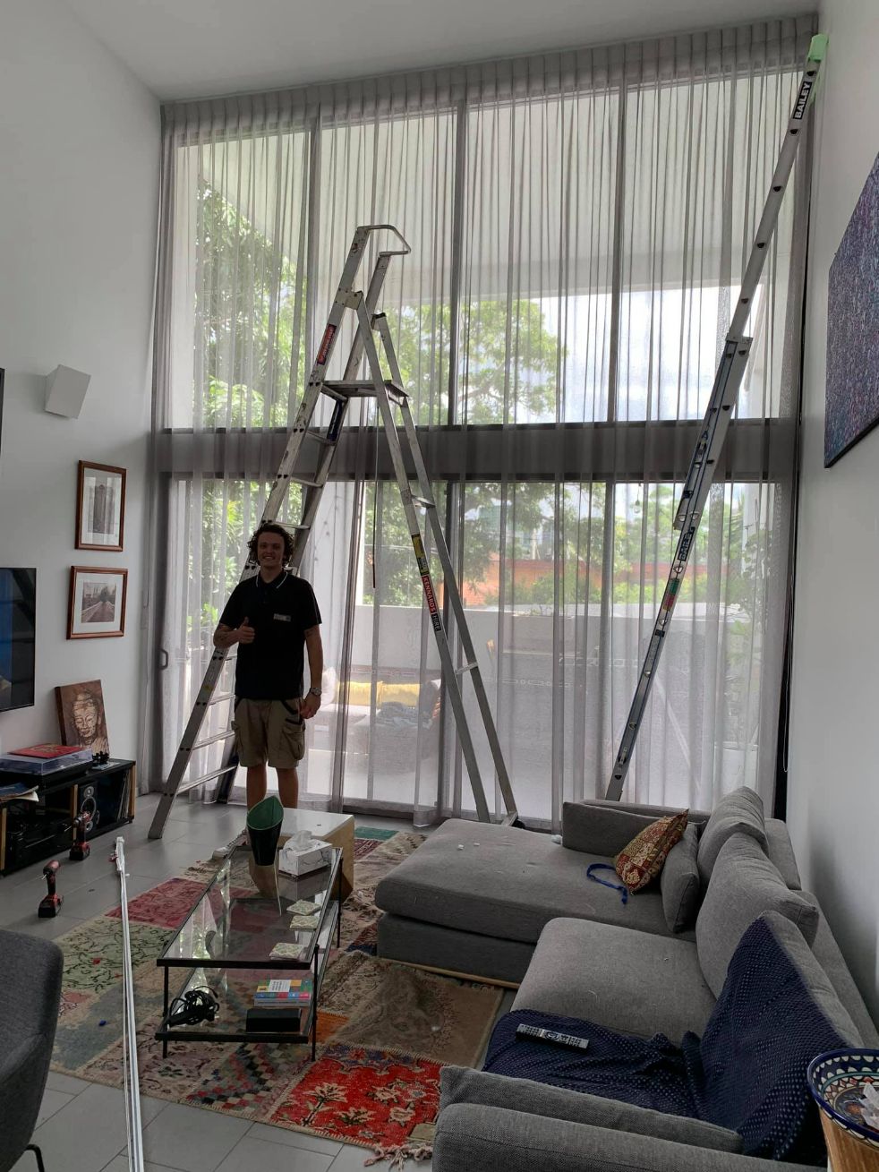 Man Installed An Inverted Pleat Curtains On A High Ceiling — Studio Curtains & Blinds in Mount Gravatt, QLD