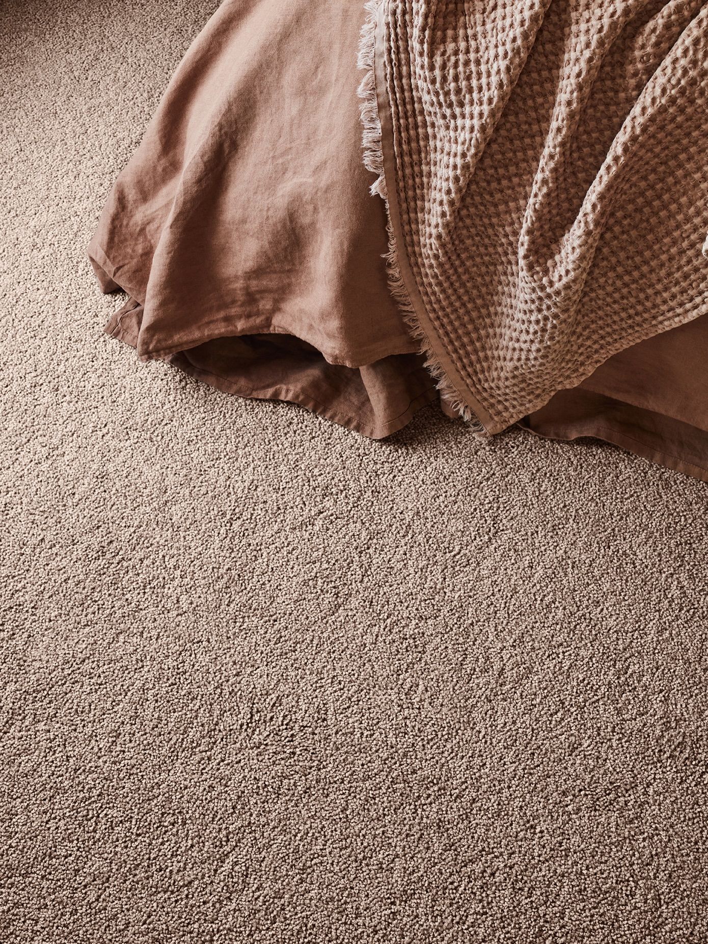 Close-up of a brown blanket draped on a beige carpet. — Unique Floors In New Town, TAS