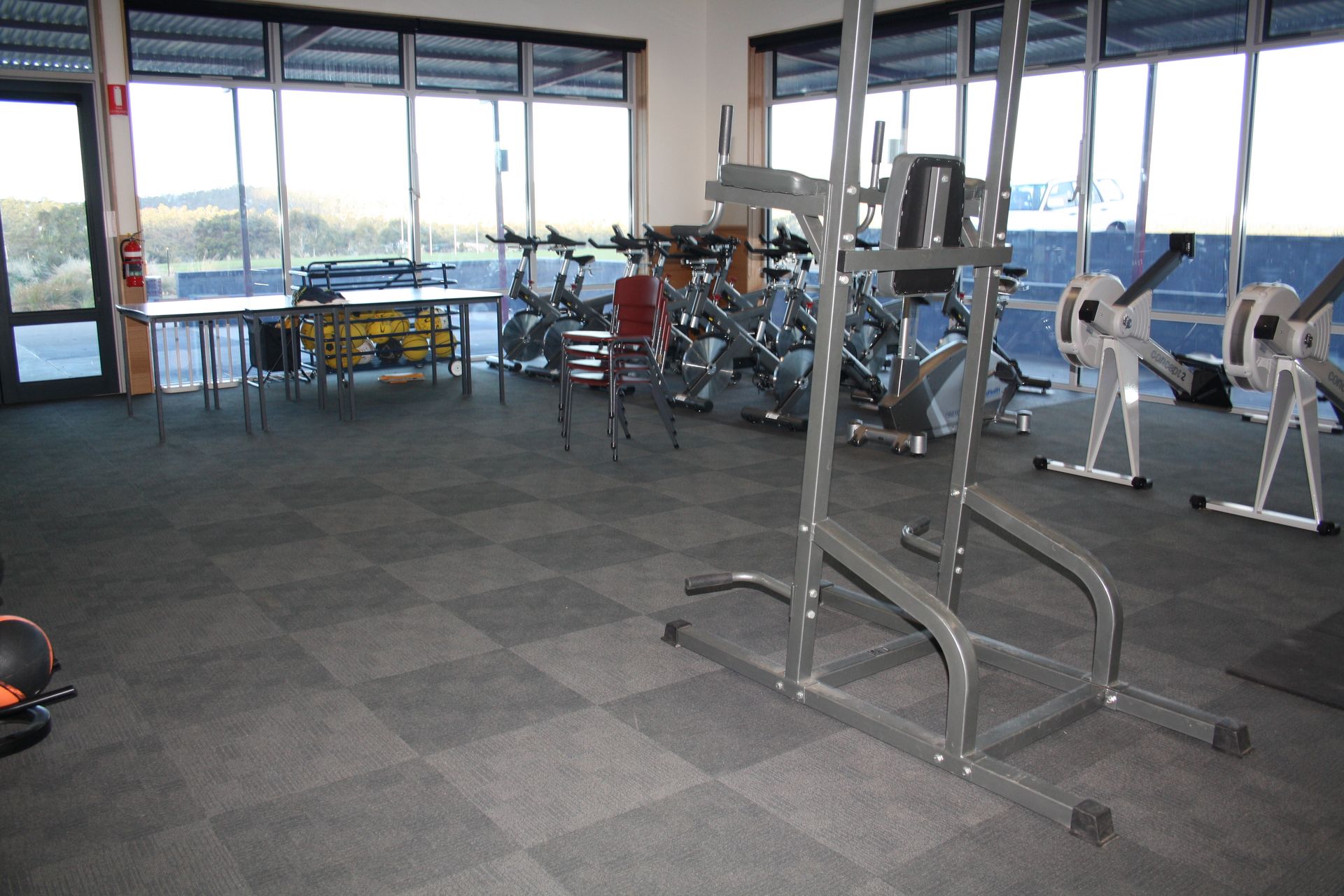 Empty gym with exercise machines and large windows overlooking a view outside — Unique Floors In New Town, TAS