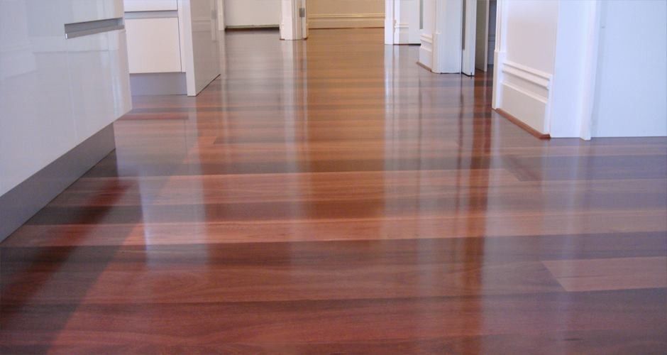 Glossy Hardwood Floor in a Bright Hallway With White Walls and Doorways — Unique Floors In New Town, TAS