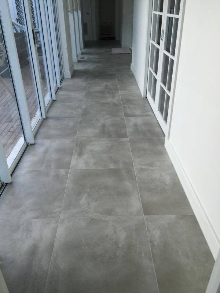 Empty Indoor Hallway With Grey Tile Floor and White Walls, Lined With Glass Doors on the Left — Unique Floors In New Town, TAS