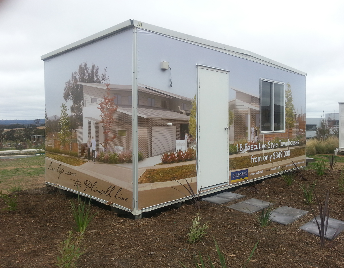 A small building with a picture of a house on it