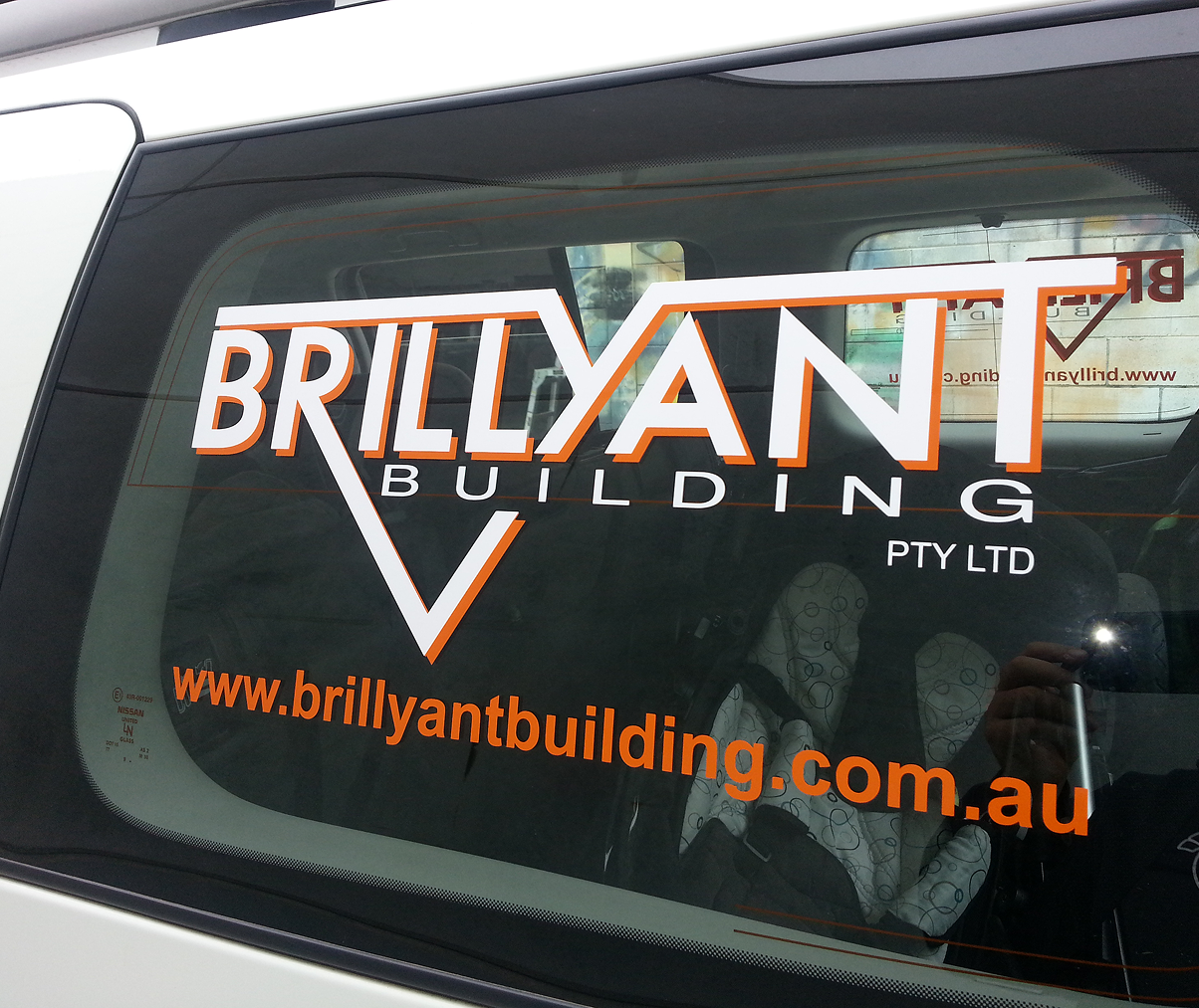 A car with a brilliant building sticker on the window