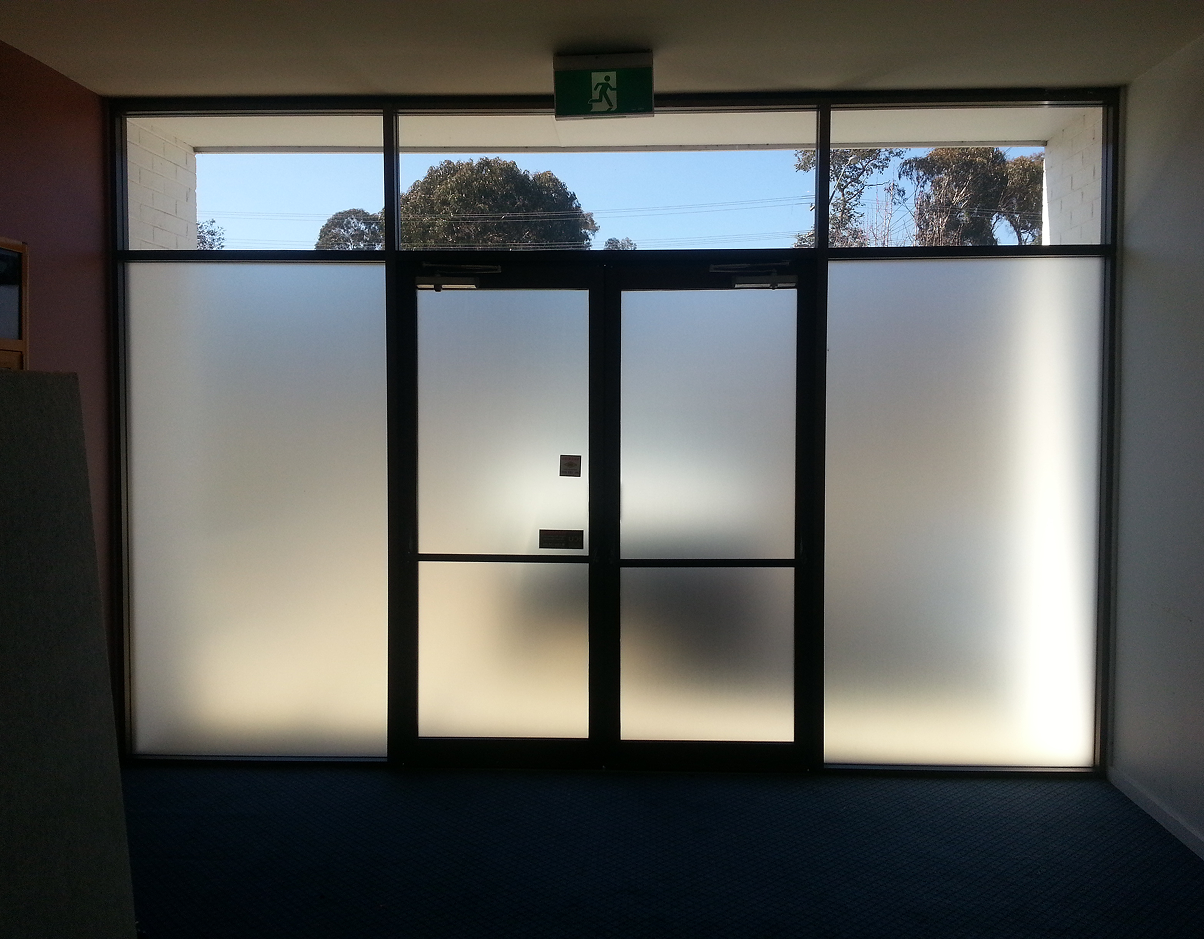 A door with a green exit sign above it