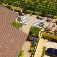 An aerial view of a wedding venue with a car parked in front of it.