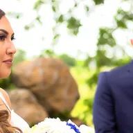 A bride and groom are standing next to each other at their wedding ceremony.
