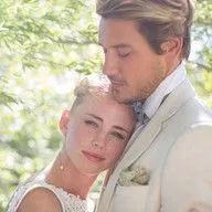 A bride and groom are posing for a picture on their wedding day.