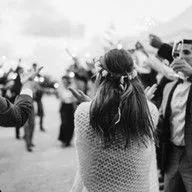 A bride and groom are dancing with sparklers at their wedding reception.