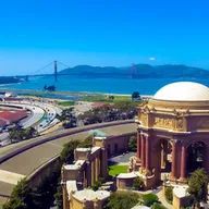 An aerial view of the palace of fine arts in san francisco with the golden gate bridge in the background.