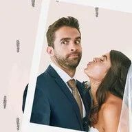 A man in a suit and tie is kissing a woman on the cheek.
