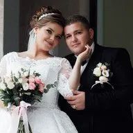 A bride and groom are posing for a picture on their wedding day.