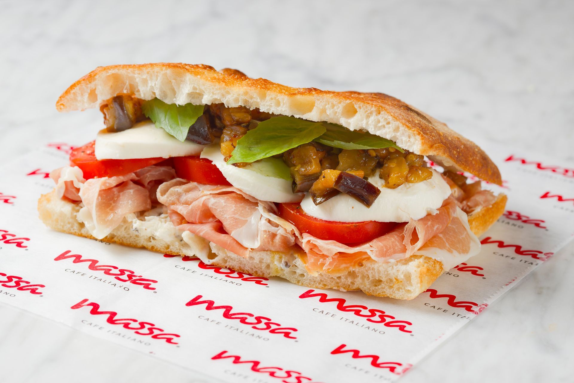 A sandwich is sitting on a piece of paper that says mesa