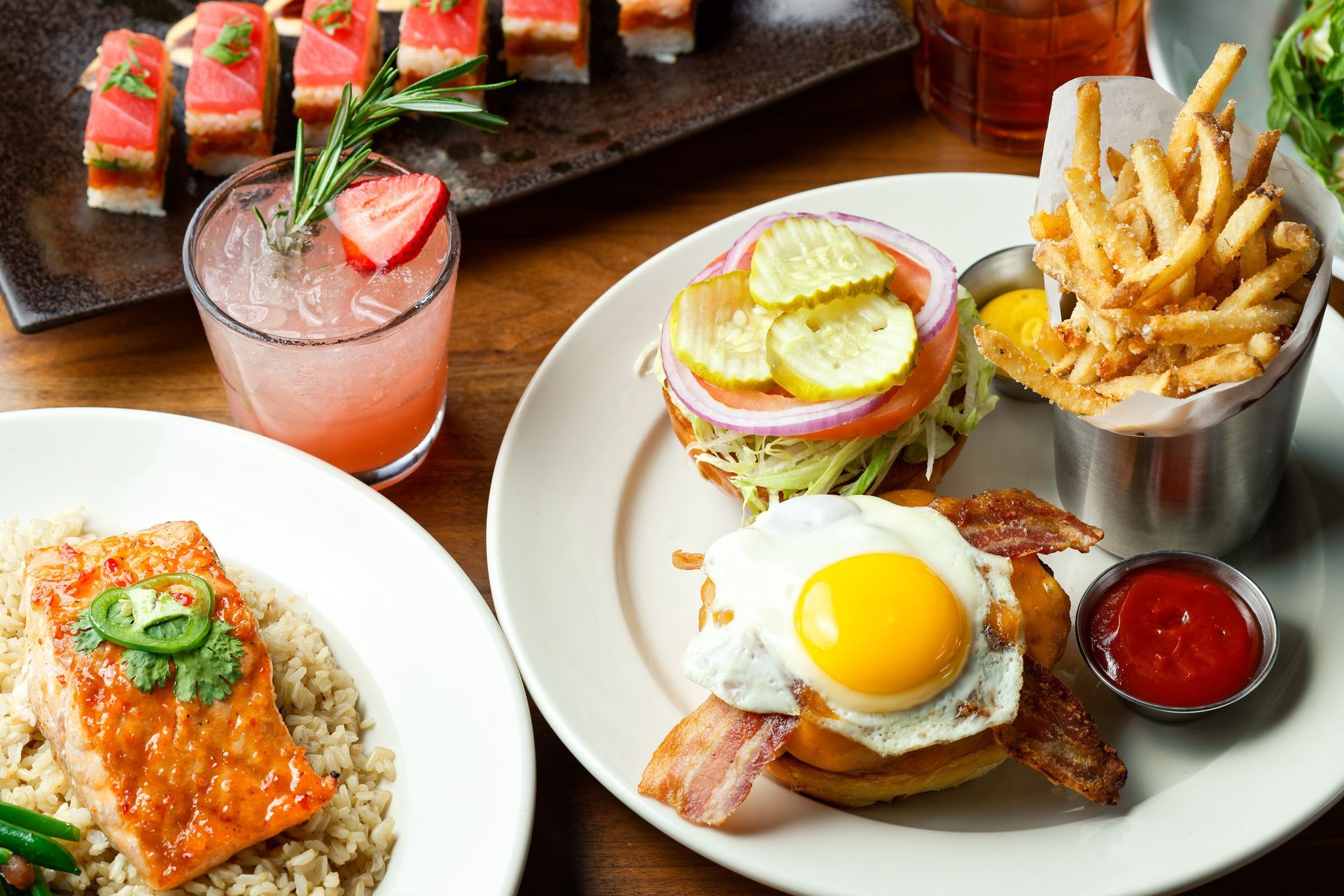 A table topped with plates of food and drinks.