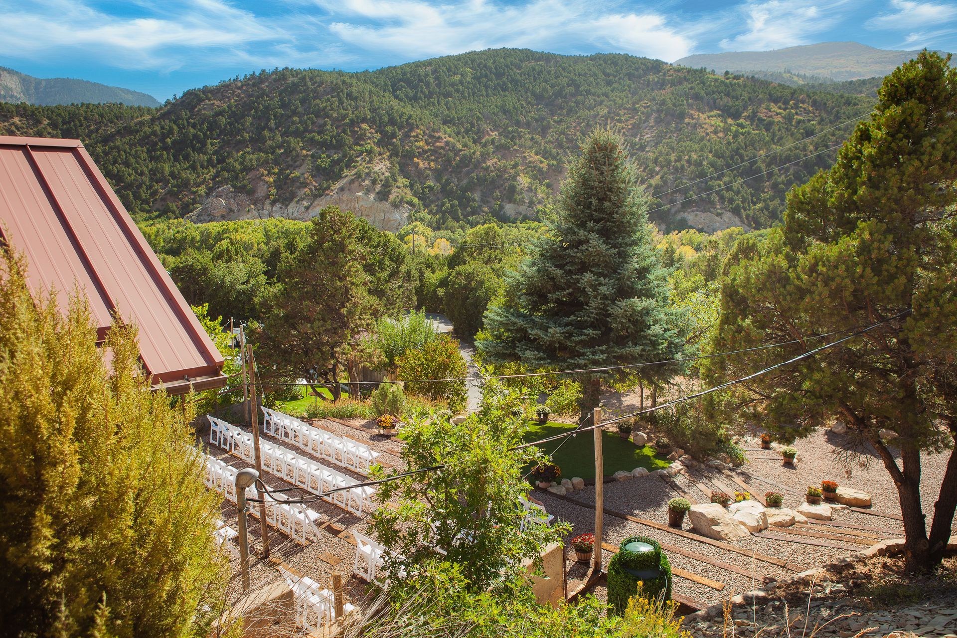 A train is going down the tracks in the mountains.