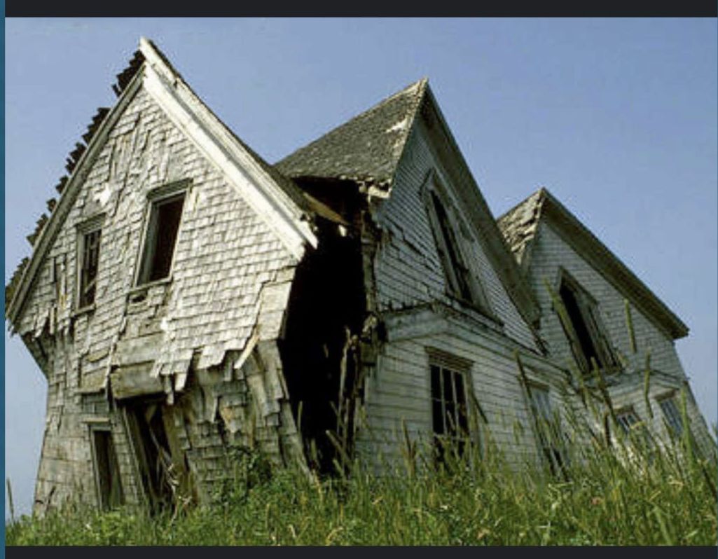 An old abandoned house with a roof that has fallen off