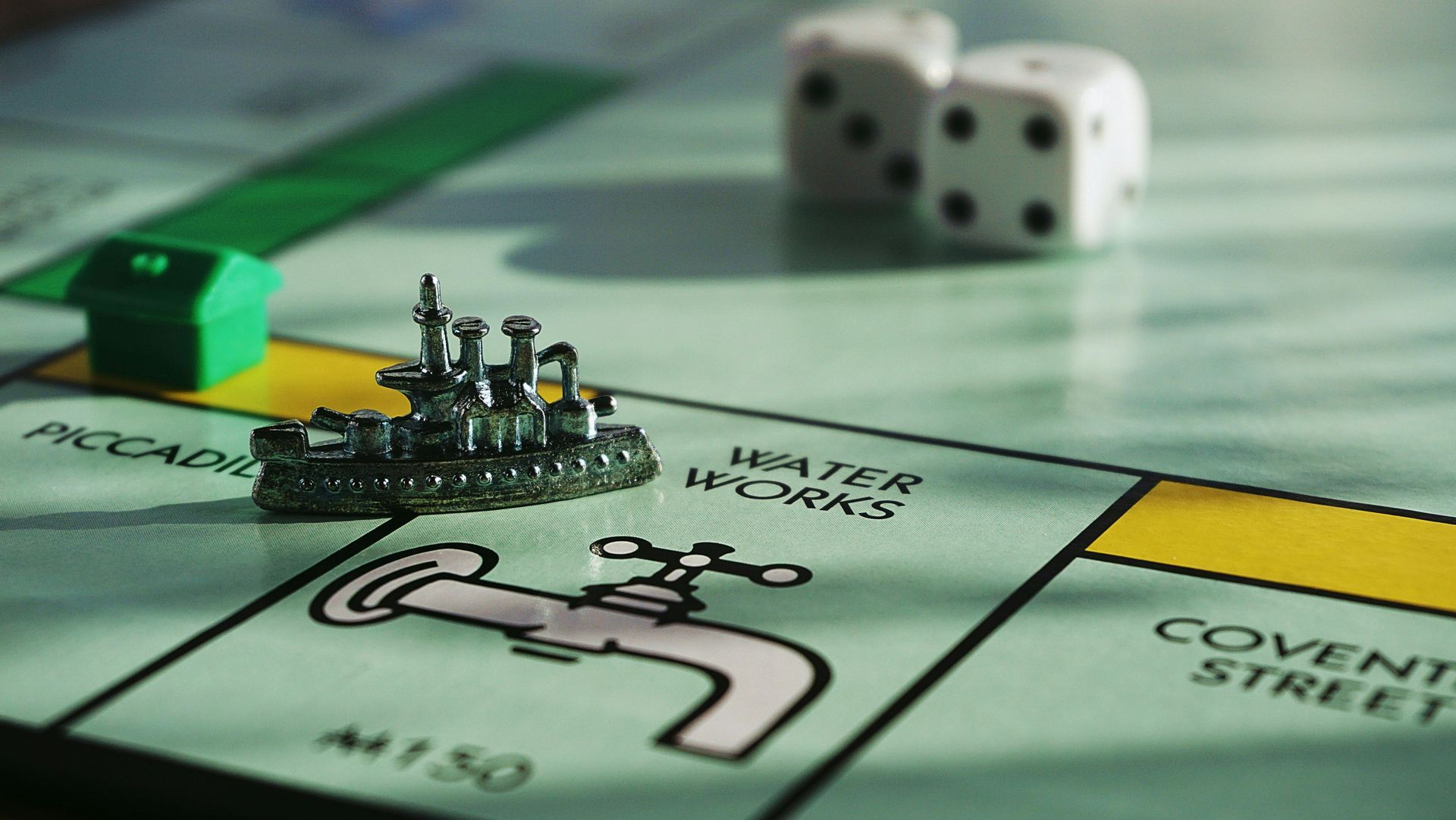 A monopoly board with a faucet and dice on it