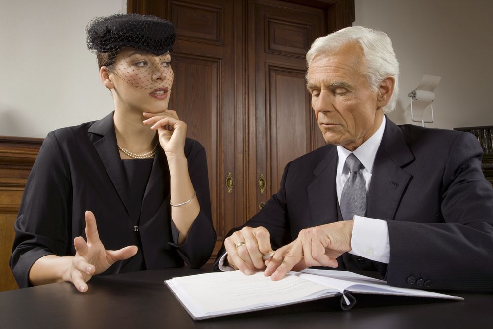 Two professionals discussing a document at a table in a wood-paneled office -  GMS Legal & Conveyancing In 38 Canton Beach Rd, Toukley
