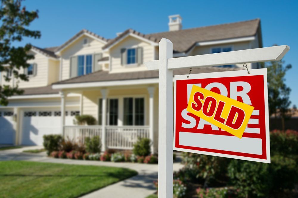 Real estate sign with “SOLD” in front of a suburban house — GMS Legal & Conveyancing In 38 Canton Beach Rd Toukley, NSW