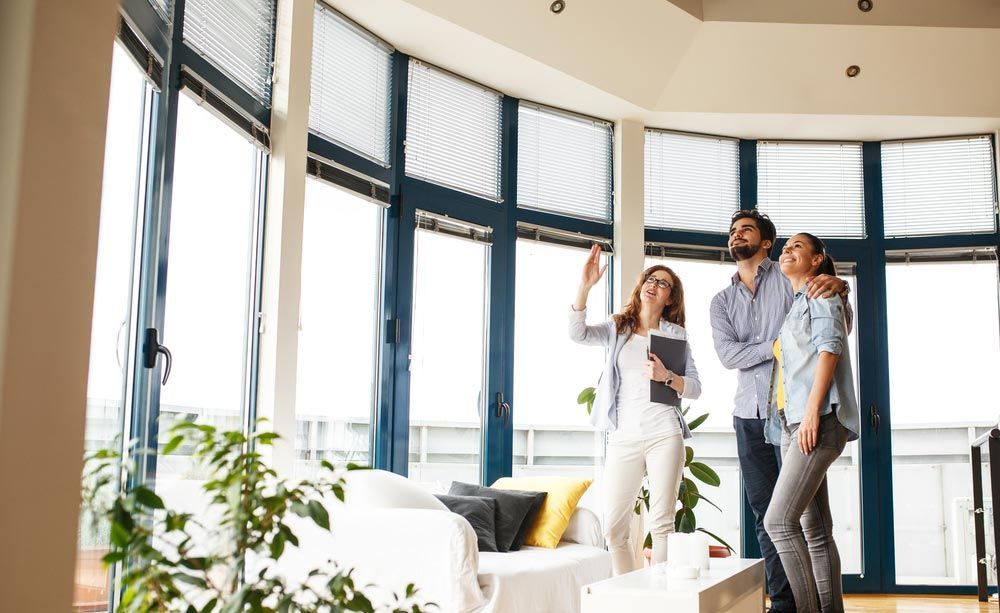 A Couple Looking Inside The House — GMS Legal & Conveyancing In 38 Canton Beach Rd Toukley, NSW