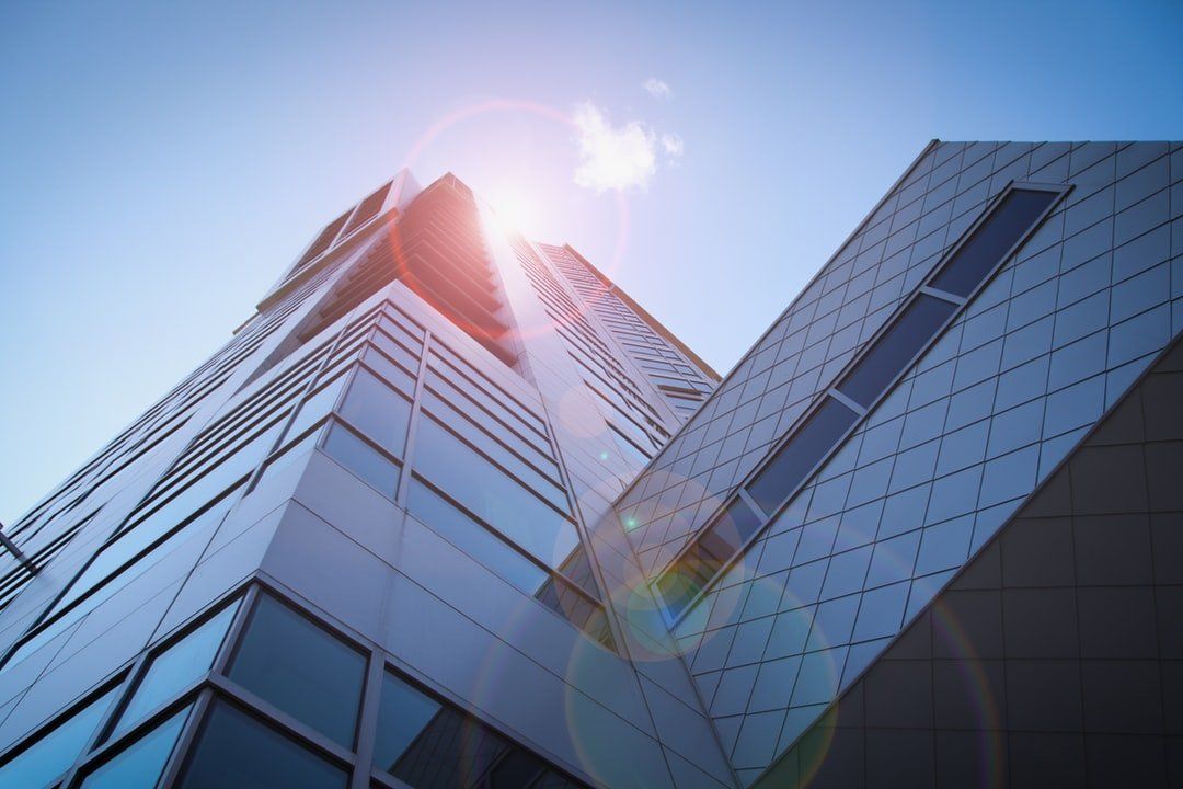 Looking up at a tall building in the city, representing the topic of business law services.