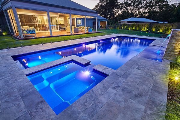 There is a Large Swimming Pool in the Backyard of a House — Aqualine Pools in Branyan, QLD