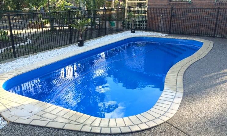 A Swimming Pool With a Beige Tile Border — Aqualine Pools in Branyan, QLD