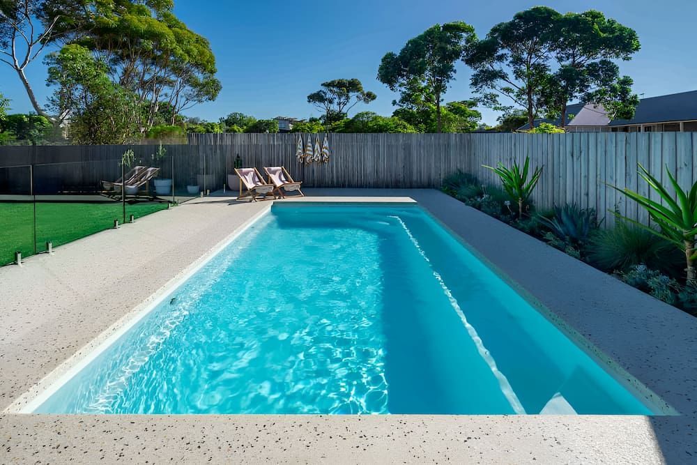 A Large Swimming Pool in the Backyard of a House — Aqualine Pools in Branyan, QLD 