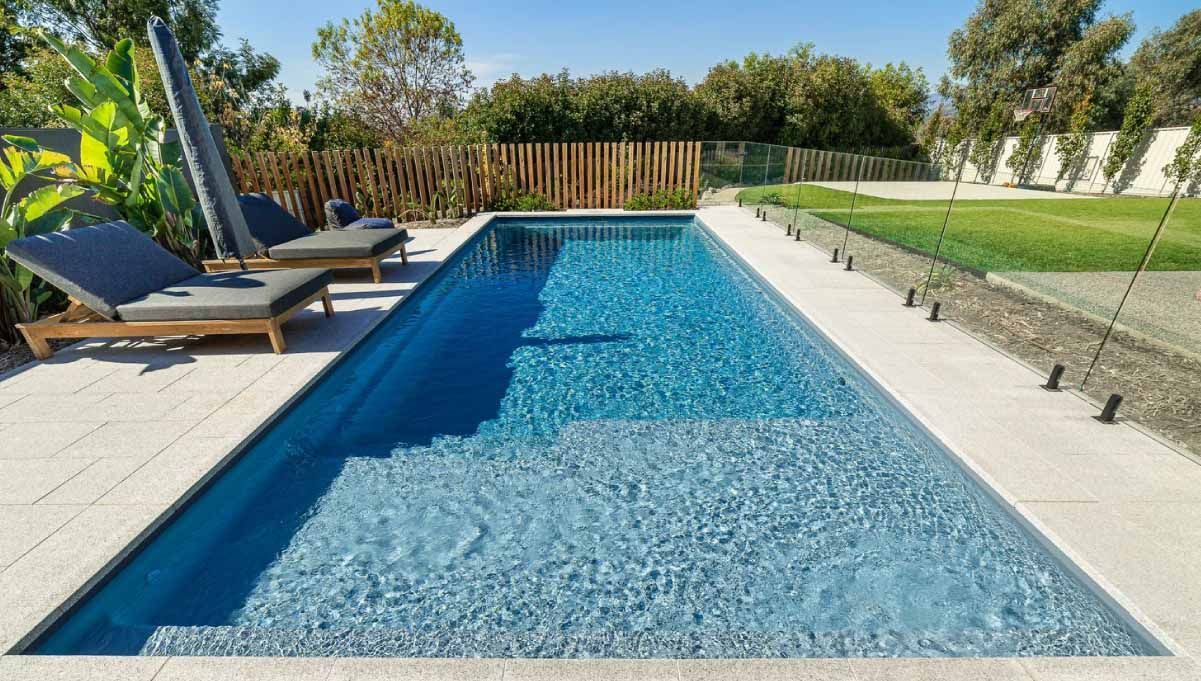 A Large Swimming Pool in the Backyard of a House — Aqualine Pools in Coral Cove, QLD