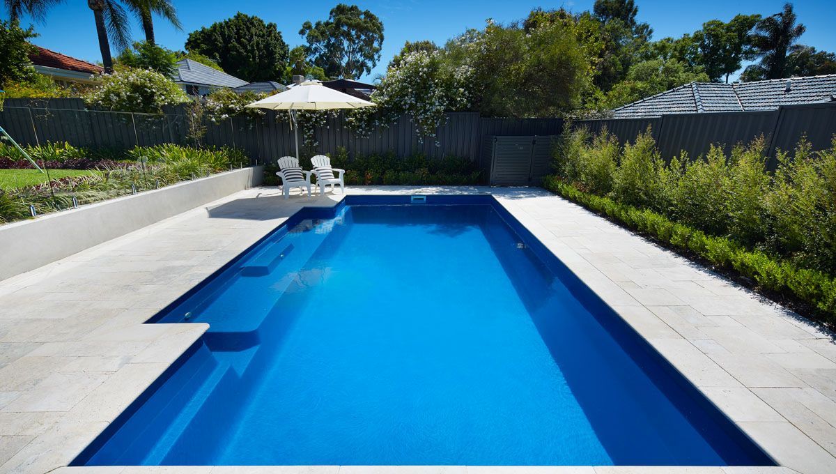 A Large Swimming Pool is Surrounded by a Fence and Gravel — Aqualine Pools in Coral Cove, QLD