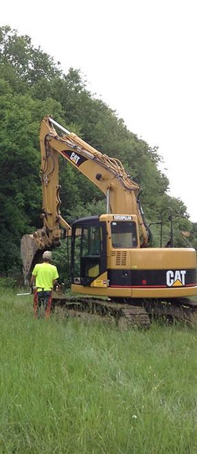 backhoe with the driver in the forest